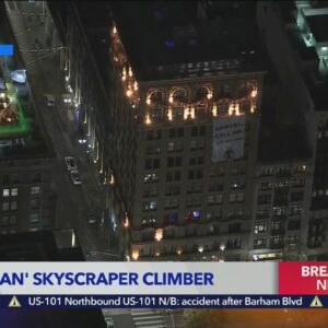 Spider-Man climbs downtown building