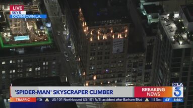 Spider-Man climbs downtown building