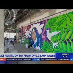 Street artists paint murals on top floor of U.S. Bank Tower in Los Angeles