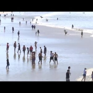 Beachgoers flock to the coast seeking relief from hot temperatures
