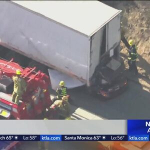 2 dead as car crashes into big rig