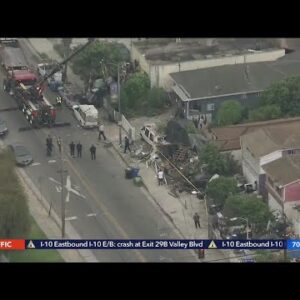 2 people after car crashes into Watts lawn