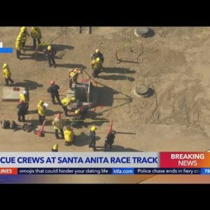 Firefighters work to free man from maintenance hole at Santa Anita Race Track