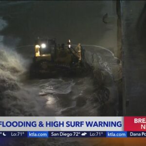Long Beach crews continue to shore up berms against high tide