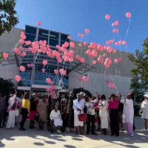 Church members release pink balloons to raise awareness