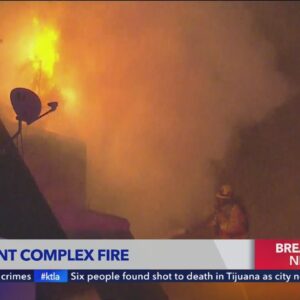 Fire crews tackle Downey apartment building engulfed in flames