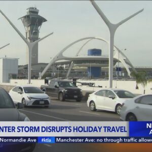 Holiday travelers brace for winter storm and record crowds