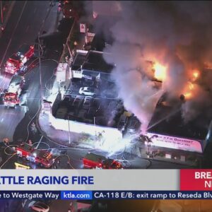 Crews battle raging fire at auto-body shop