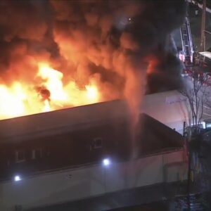 Crews tackle large building fire in Van Nuys