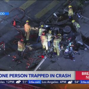 Crews working to rescue person trapped in vehicle after crash