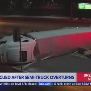 Driver has to be rescued after semi-truck overturns on 210 freeway