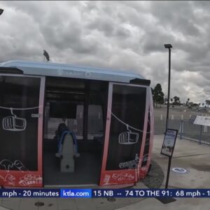 As proposed gondola displayed at Dodger Stadium, demonstrators rally against the aerial transit