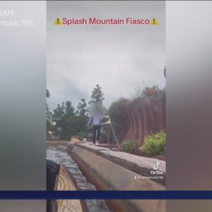 Rider jumps off Splash Mountain ride