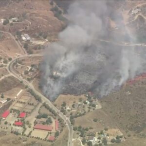 Brush fire burns structures in Riverside County