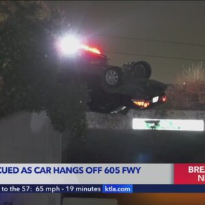 Driver rescued from overturned vehicle hanging off side of 605 Freeway 