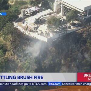 Firefighters battling blaze beneath Hollywood Hills homes