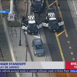 Police standoff underway with Uber passenger armed with a gun
