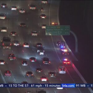 Car dumps lumber on 91 freeway, causing major backups