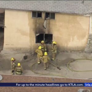 A man was found beaten to the death at the scene of a house fire in Tujunga. His son has been taken