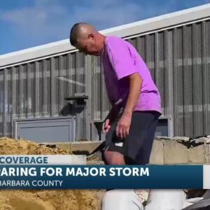 Locals prepare for storm impact by packing sandbags