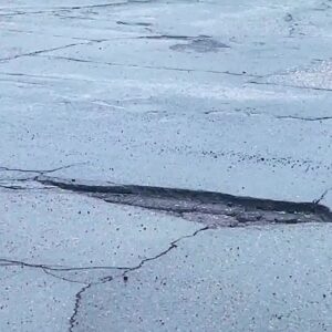 Residents warn each other to be cautious on the roads as rain brings out potholes in Santa ...