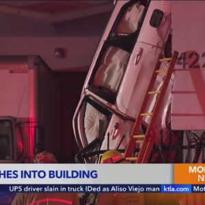 Car gets lodged against building after crash in Vernon