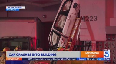 Car gets lodged against building after crash in Vernon