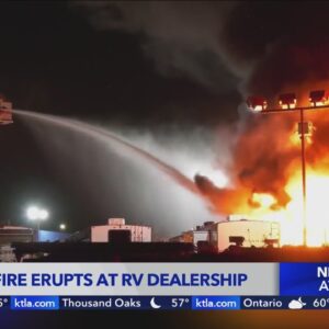 Massive fire erupts at RV dealership