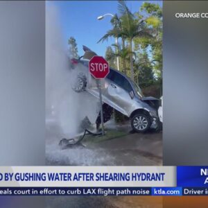 Car suspended by gushing water after crash in Lake Forest