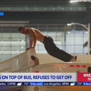 Man climbs on top of bus, refuses to come down for hours in downtown Los Angeles 