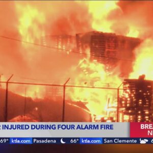 Firefighter injured after blaze torches stacked pallets, vehicles, trucks and trailers