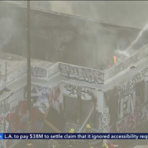 Crews respond as fire burns through roof of DTLA building