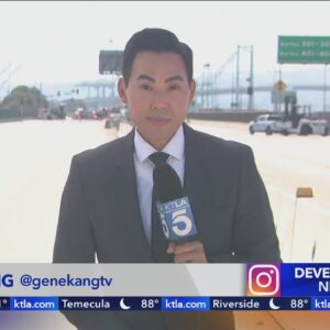 Workers clearing burned-out semi from San Pedro freeway