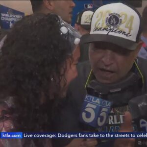 Dodgers players celebrate in the locker room after their World Series win