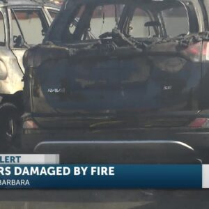 Firefighters on the scene of two cars on fire in parking structure on Anacapa Street Thursday