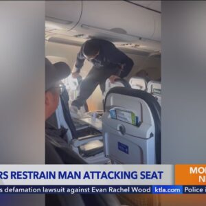 United Airlines passenger restrained after attacking own seat