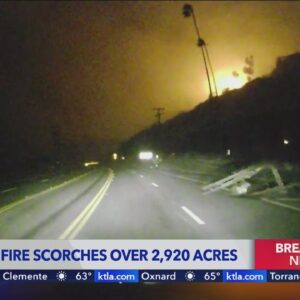 Palisades Fire: Utility pole, debris and flames seen from the Pacific Coast Highway