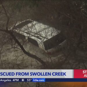 Driver rescued from swollen creek in Orange County